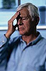 Picture of an elderly man clenching his aching head