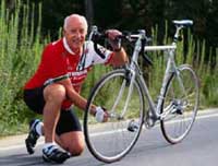 Picture of a elderly man adjusting his bicycle tire