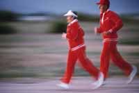 Picture of two people in proper exercise gear, jogging