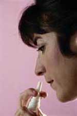 Picture of a woman using nasal spray