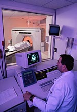 A picture of patient and technologist during a CT scan