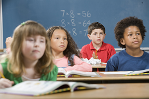 Children sitting at desks in a classroom