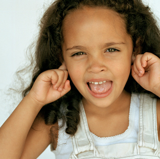 Child with her fingers in her ears.